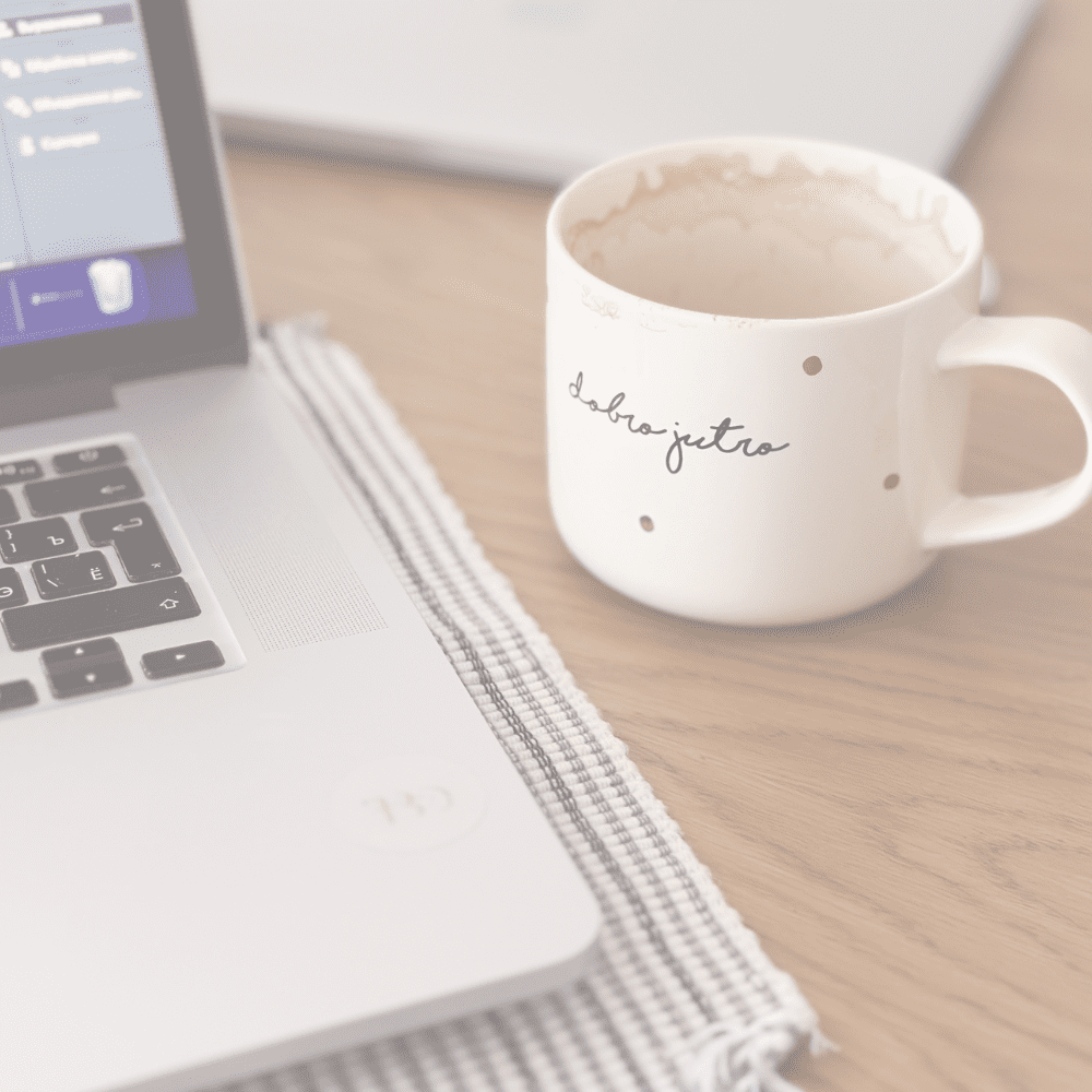 Laptop and coffee mug showing website copywriter work